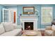 Living room features a cozy fireplace, shuttered windows, and comfortable seating at 556 21St Ne Ave, St Petersburg, FL 33704
