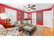 Comfortable living room featuring a sofa, patterned armchairs, and hardwood floors at 556 21St Ne Ave, St Petersburg, FL 33704