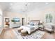 Spacious bedroom with a decorative rug, modern lighting, and neutral decor at 556 21St Ne Ave, St Petersburg, FL 33704
