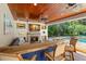 Inviting outdoor bar and entertainment area with a stone fireplace and views of the pool and lush greenery at 556 21St Ne Ave, St Petersburg, FL 33704