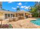 The covered outdoor area includes an outdoor kitchen with bar seating, fireplace and a pool with spa at 556 21St Ne Ave, St Petersburg, FL 33704