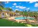 This backyard oasis features a pool, spa, putting green, and a covered outdoor seating area, perfect for entertaining at 556 21St Ne Ave, St Petersburg, FL 33704