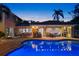 Outdoor pool at dusk featuring lounge area, bar, and in-ground pool lighting at 556 21St Ne Ave, St Petersburg, FL 33704