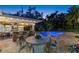 Outdoor bar and patio area overlooking a stunning pool and lush greenery at 556 21St Ne Ave, St Petersburg, FL 33704