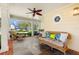 Inviting porch with wicker furniture, ceiling fan, and swing, perfect for enjoying outdoor living at 556 21St Ne Ave, St Petersburg, FL 33704