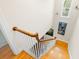 Bright staircase featuring wood steps, white railings, and stylish artwork creates an inviting transition between floors at 556 21St Ne Ave, St Petersburg, FL 33704