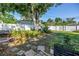 Lush backyard featuring a well-maintained lawn, mature trees, and a white fence at 633 47Th N Ave, St Petersburg, FL 33703