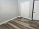 The bedroom features gray walls, wood-look floors and white doors at 633 47Th N Ave, St Petersburg, FL 33703