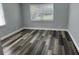 Bedroom featuring wood-look floors, base-molding, and natural light at 633 47Th N Ave, St Petersburg, FL 33703
