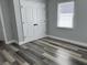 This bedroom offers natural light from the window and neutral walls with wood-look floors at 633 47Th N Ave, St Petersburg, FL 33703