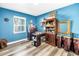 Bedroom with wood-look floors and large window providing natural light at 633 47Th N Ave, St Petersburg, FL 33703