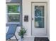 Close-up of the front entrance with a mailbox, a chair, and a decorative plant at 633 47Th N Ave, St Petersburg, FL 33703