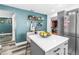 Bright kitchen features stainless steel appliances, and white countertops with a prep island and eat-in counter at 633 47Th N Ave, St Petersburg, FL 33703