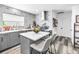 Bright kitchen features gray cabinetry, stainless steel appliances, and white countertops with a prep island at 633 47Th N Ave, St Petersburg, FL 33703