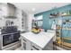 Bright kitchen features stainless steel appliances, and white countertops with a prep island and eat-in counter at 633 47Th N Ave, St Petersburg, FL 33703