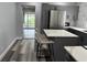 Open concept kitchen with stainless steel appliances, gray cabinets, and an island for seating at 633 47Th N Ave, St Petersburg, FL 33703