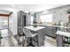Modern kitchen with stainless steel appliances, a stylish island, and eye-catching backsplash at 633 47Th N Ave, St Petersburg, FL 33703