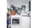 Functional laundry area featuring a front-load washer and dryer with storage and utility features at 633 47Th N Ave, St Petersburg, FL 33703