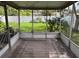 Screened porch with large outdoor rug and views of the fenced-in backyard with mature landscaping at 633 47Th N Ave, St Petersburg, FL 33703
