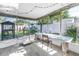 Relaxing screened-in porch with a spacious seating area and parrot at 633 47Th N Ave, St Petersburg, FL 33703
