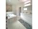 Luxurious bathroom features a soaking tub, double vanity and large tiled shower at 7044 Brickell Ct, Spring Hill, FL 34609