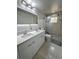 Modern bathroom with double sinks, luxurious shower, contemporary fixtures, and decorative lighting at 7044 Brickell Ct, Spring Hill, FL 34609