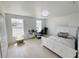 Bright bedroom with wood floors, desk, and large window providing plenty of natural light at 7044 Brickell Ct, Spring Hill, FL 34609