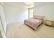 Clean bedroom with modern light fixture, neutral color scheme, and bright hardwood floors at 7044 Brickell Ct, Spring Hill, FL 34609