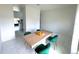 Bright dining room features tiled floors and a modern wood dining table with green velvet chairs at 7044 Brickell Ct, Spring Hill, FL 34609