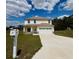 Two-story home with a two-car garage, manicured lawn and charming curb appeal at 7044 Brickell Ct, Spring Hill, FL 34609