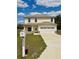 Two-story home with a two-car garage, manicured lawn and charming curb appeal at 7044 Brickell Ct, Spring Hill, FL 34609