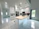 Bright, modern kitchen features white cabinets, a large center island, and stainless steel appliances at 7044 Brickell Ct, Spring Hill, FL 34609