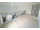 Bright loft area with chandelier, light floors, modern railing and plenty of natural light at 7044 Brickell Ct, Spring Hill, FL 34609