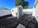 Backyard shed with dark mulch and a white privacy fence at 7114 Parrot Dr, Port Richey, FL 34668