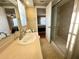 Bathroom featuring a shower with a glass door and neutral wall and floor tiles at 7114 Parrot Dr, Port Richey, FL 34668