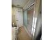 Bathroom featuring a shower with a sliding glass door and neutral wall and floor tiles at 7114 Parrot Dr, Port Richey, FL 34668