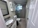 Bathroom featuring granite vanity, decorative glass door shower, and overhead cabinet at 7114 Parrot Dr, Port Richey, FL 34668