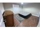 Bedroom with wood floors, window and air mattress on gray patterned rug at 7114 Parrot Dr, Port Richey, FL 34668