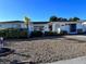 Inviting single-story home with a well-kept lawn, mature palm tree, and neutral-colored exterior for a serene curb appeal at 7114 Parrot Dr, Port Richey, FL 34668