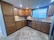 Well-lit kitchen featuring ample wood cabinetry, stainless steel dishwasher, and granite countertops at 7114 Parrot Dr, Port Richey, FL 34668