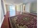 Bright living room with hardwood floors, neutral walls, and a sliding glass door leading to the outdoor pool area at 7114 Parrot Dr, Port Richey, FL 34668