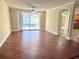 Open living area with hardwood floors, direct access to a screened pool, and seamlessly connects to the kitchen at 7114 Parrot Dr, Port Richey, FL 34668