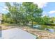Scenic backyard with mature trees and water views, featuring a patio area at 7336 Cherry Laurel Dr, Port Richey, FL 34668