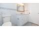 Bathroom with a white vanity, quartz countertop, marble tile, and modern fixtures at 7336 Cherry Laurel Dr, Port Richey, FL 34668