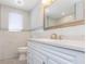 Elegant bathroom with modern vanity, quartz countertop, and decorative accent tiles at 7336 Cherry Laurel Dr, Port Richey, FL 34668