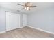 Bedroom featuring wood floors, closet, and double door entrance at 7336 Cherry Laurel Dr, Port Richey, FL 34668