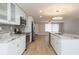 Open concept kitchen features an island with granite countertop and stainless appliances, blending living spaces at 7336 Cherry Laurel Dr, Port Richey, FL 34668