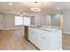 View of a kitchen island that is granite topped, with an open view to the rest of the house at 7336 Cherry Laurel Dr, Port Richey, FL 34668