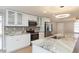 Modern kitchen with white cabinets, granite countertops, stainless steel appliances, and an island sink at 7336 Cherry Laurel Dr, Port Richey, FL 34668