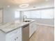 Kitchen with a granite topped island, stainless appliances, and light-colored wood look flooring at 7336 Cherry Laurel Dr, Port Richey, FL 34668